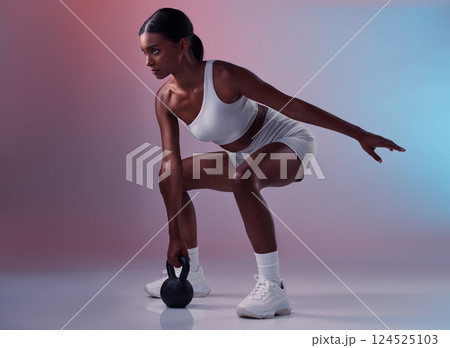 Fitness, kettlebell and woman training in studio for full body balance, powerful muscles and strong arms. Sports, exercise and healthy Indian girl swinging weights or weightlifting in a squat pose Fitness, kettlebell and woman training in studio for full body balance, powerful muscles and strong arms. Sports, exercise and healthy Indian girl swinging weights or weightlifting in a squat pose 124525103