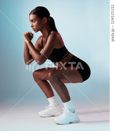Squat, fitness and woman in studio for exercise, body workout and training legs for strong powerful thigh muscles. Focus, wellness and healthy Indian girl squats with energy and balance in aerobics Squat, fitness and woman in studio for exercise, body workout and training legs for strong powerful thigh muscles. Focus, wellness and healthy Indian girl squats with energy and balance in aerobics 124525152