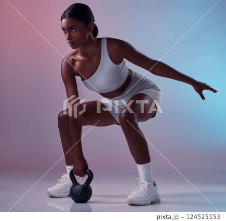 Woman, kettle bell weights or workout on studio background for strong body muscles, exercise or training. Personal trainer, sports person or fitness model weightlifting heavy metal in health wellness 124525153