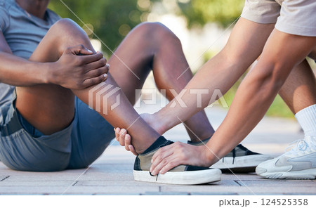 Feet, hands and sports injury by fitness friends on the floor during exercise in the city, holding and hurt. Shoes, hand and ankle pain by sport people on ground for injury, muscle and foot problem 124525358