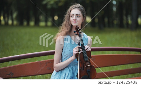 Portrait of a young girl with her violin. Portrait of a young girl with her violin. 124525438