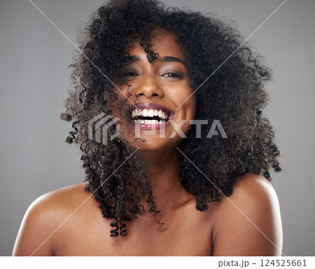 Face, hair care and beauty smile of black woman on gray studio background. Portrait, makeup and female model from Jamaica with beautiful, healthy head of hair and curls after spa cosmetics treatment 124525661