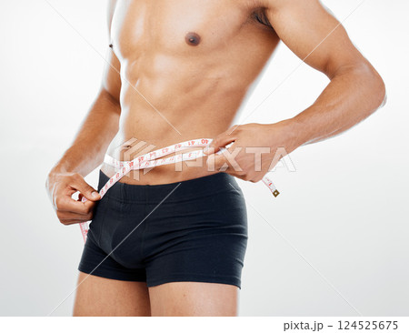 Health, diet and body of man with tape measure to check progress, fitness results and measure stomach waist. Weight loss goals, wellness mindset motivation and underwear model on white background Health, diet and body of man with tape measure to check progress, fitness results and measure stomach waist. Weight loss goals, wellness mindset motivation and underwear model on white background 124525675