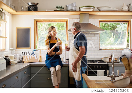 Love, wine and mature couple in kitchen cooking, drinking and spending free time together in home. Retirement, happy man and woman with wine glass, smile and apron relax before dinner in modern house Love, wine and mature couple in kitchen cooking, drinking and spending free time together in home. Retirement, happy man and woman with wine glass, smile and apron relax before dinner in modern house 124525808