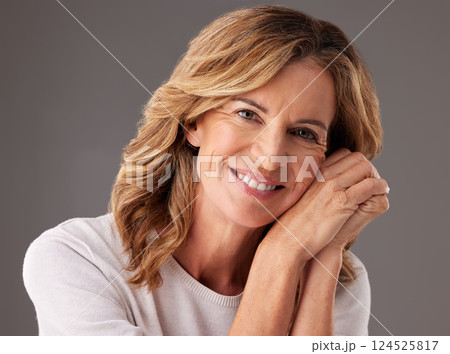 Mature woman, beauty and happy with skincare, face and anti aging cosmetics against a grey studio background. Senior model with clean face, wellness and dermatology routine with healthy glowing skin 124525817