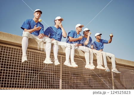 Sports, baseball and team of men together smiling and happy sitting in row eating apple. Smile, teamwork and professional baseball team relax watching competition game or training workout session. 124525823