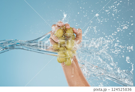 Hand, grapes and water by woman in studio for wellness, health and nutrition mockup, studio and blue background. Splash, fruit and model hands for plant, organic and nutrition skin, product and diet Hand, grapes and water by woman in studio for wellness, health and nutrition mockup, studio and blue background. Splash, fruit and model hands for plant, organic and nutrition skin, product and diet 124525836