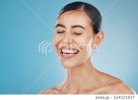 Skincare, cleaning and washing face by woman in studio for wellness, shower, happy and relax against a blue background mockup. Girl, water and face with model face wash for beauty, splash and skin Skincare, cleaning and washing face by woman in studio for wellness, shower, happy and relax against a blue background mockup. Girl, water and face with model face wash for beauty, splash and skin 124525837