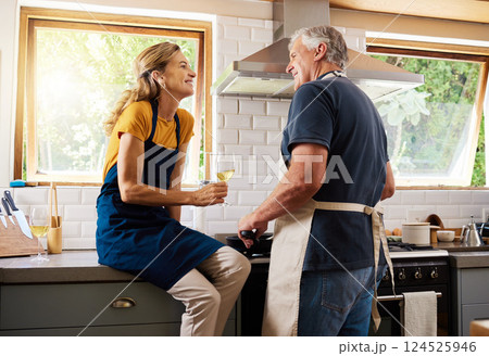 Senior couple, cooking and wine while talking, making food and for happy conversation in home kitchen for dinner date. Man helping woman with lunch for quality time, happiness and love in retirement Senior couple, cooking and wine while talking, making food and for happy conversation in home kitchen for dinner date. Man helping woman with lunch for quality time, happiness and love in retirement 124525946