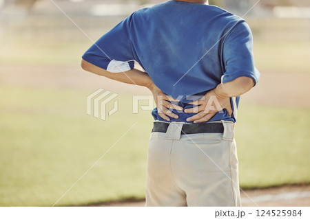 Sports, baseball injury and man with back pain, emergency or muscle strain during game, competition or fitness match. Softball player, field pitch or back view of athlete with hurt spine or backache 124525984