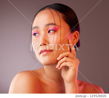 Beauty, makeup and asian woman with colourful eyeshadow isolated against a studio background. Cosmetics, glowing skin and chinese woman with glamour eye makeup. Smooth and perfect skin after a facial Beauty, makeup and asian woman with colourful eyeshadow isolated against a studio background. Cosmetics, glowing skin and chinese woman with glamour eye makeup. Smooth and perfect skin after a facial 124526026
