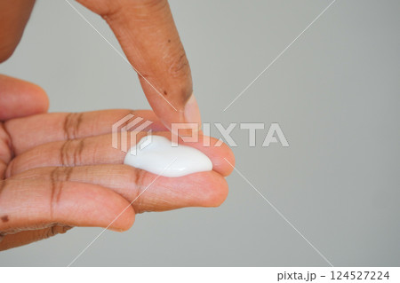 Applying moisturizer to hand with fingertip technique Applying moisturizer to hand with fingertip technique 124527224