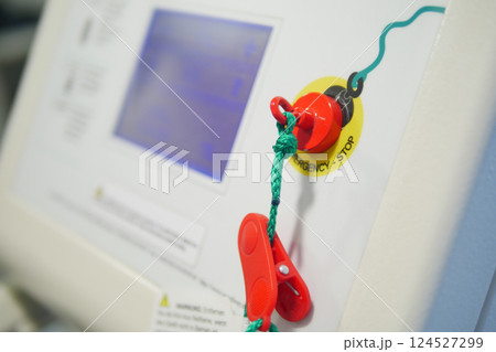 Bright red emergency stop button is prominently visible on equipment Bright red emergency stop button is prominently visible on equipment 124527299