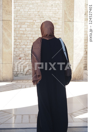 Woman in black attire exploring historic site during daytime Woman in black attire exploring historic site during daytime 124527401