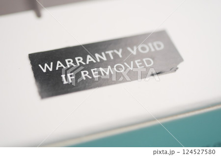 Warranty sticker on product packaging highlights important information 124527580