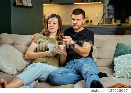 Couple Watching TV and Eating Snacks Couple Watching TV and Eating Snacks 124528027