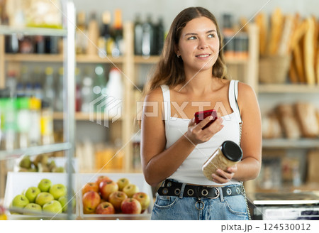 Young woman scanning qr code of beans Young woman scanning qr code of beans 124530012