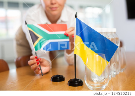 National flags of Ukraine and South Africa placed on table in meeting room 124530215