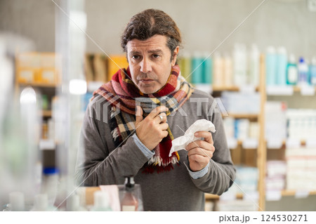 Adult man with sore throat and cough at pharmacy Adult man with sore throat and cough at pharmacy 124530271
