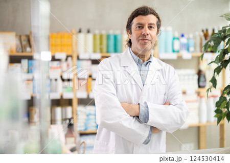 Man pharmacy employee works with computer and notebook dairy. Man pharmacy employee works with computer and notebook dairy. 124530414
