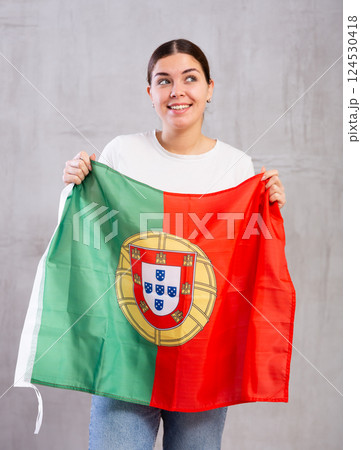 Attractive female football fan holding Portugal flag Attractive female football fan holding Portugal flag 124530418