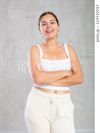 Happy young woman in casual clothes standing smiling Happy young woman in casual clothes standing smiling 124530587