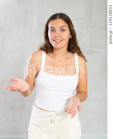 Young woman in casual clothes posing in studio 124530633