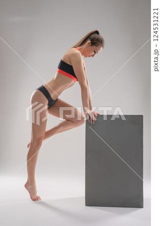 Woman posing in sporty attire during a studio photo session showcasing fitness 124531221