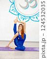 Young woman practicing an advanced yoga pose indoors 124532035