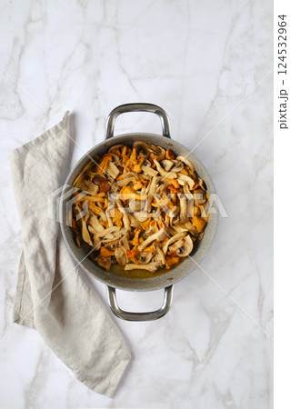 Overhead view of casserole with chopped assortment of mushrooms 124532964