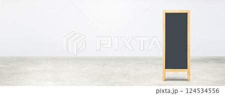 Blank blackboard on a concrete floor with a white wall. Blank blackboard on a concrete floor with a white wall. 124534556