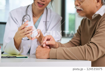 Doctor Explaining Medication to Senior Patient During Medical Consultation Doctor Explaining Medication to Senior Patient During Medical Consultation 124535075