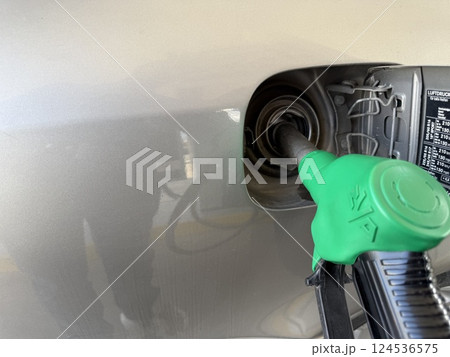Car refueling on a petrol station. Closeup photography of a car and a gas station. Car refueling on a petrol station. Closeup photography of a car and a gas station. 124536575