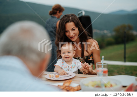 Portrait of cute baby girl during spring outdoor barbecue. Portrait of cute baby girl during spring outdoor barbecue. 124536667