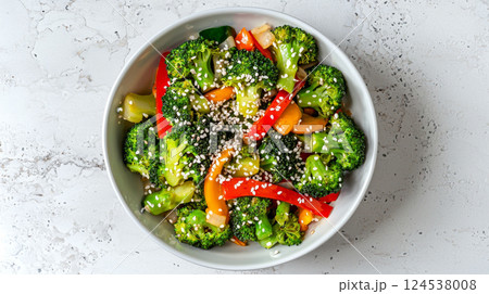 Top view of fresh asian-style broccoli stir fry with sesame seeds and colorful vegetables. concept of healthy eating, vibrant colors, nutritious meals, vegetarian diet 124538008