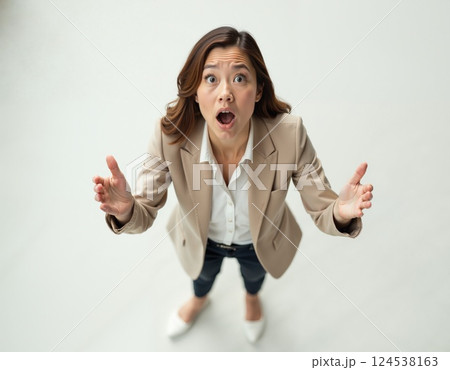 Surprised woman in business attire expressing enthusiasm and shock 124538163