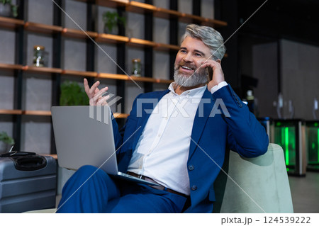 Gray-haired mature business man in elegant suit in his working place 124539222