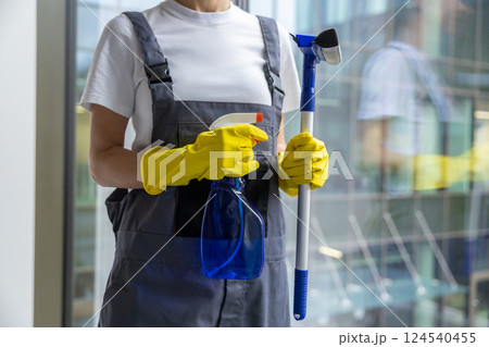 Female cleaner standing with the window washer in her hands 124540455