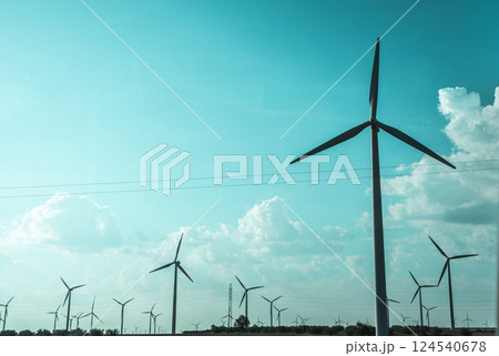 Wind turbines with propellers Energy generator on wind farm against blue sky. Natural renewable energy. Future technologies. Harnessing wind power. Wind turbines with propellers Energy generator on wind farm against blue sky. Natural renewable energy. Future technologies. Harnessing wind power. 124540678