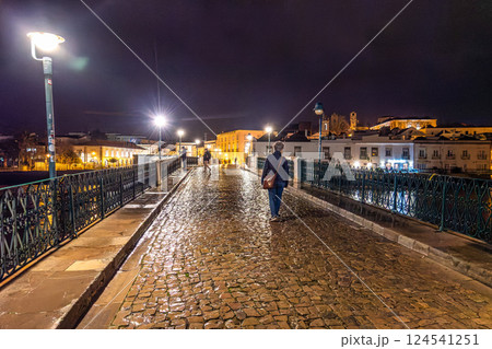 Tavira, Portugal - Feb 11, 2025: Roman bridge in Tavira, Algarve, Portugal at night. Ponte Romana bridge in Tavira town 124541251