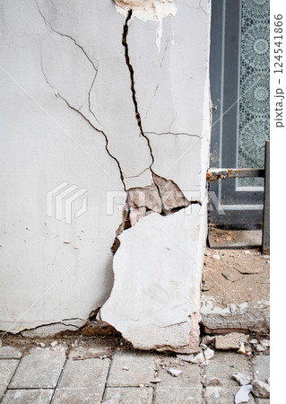 Cracked Wall with Missing Plaster Near Window. Building emergency condition 124541866