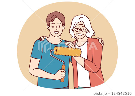 Grandmother hugging grandson doing repairs and using roller to paint walls in apartment 124542510