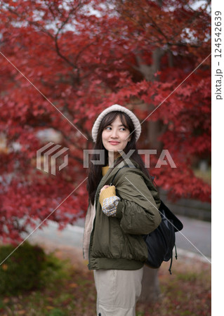 Portrait of a young Asian woman with autumn leaves 124542639