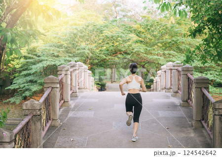 asian woman jogger, running over the bridge in public park. 124542642