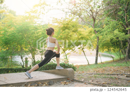Female jogger. Fit young Asian woman with sportswear stretching muscle in park before running and enjoying healthy outdoor. Fitness runner girl in public park. Wellness being concept Female jogger. Fit young Asian woman with sportswear stretching muscle in park before running and enjoying healthy outdoor. Fitness runner girl in public park. Wellness being concept 124542645