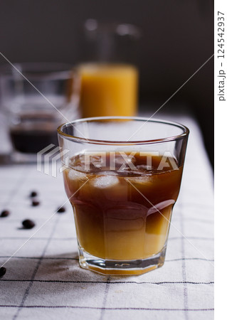 Refreshing bumble coffee, orange juice espresso, iced orange juice coffee on a table with coffee beans around, close up, summer concept Refreshing bumble coffee, orange juice espresso, iced orange juice coffee on a table with coffee beans around, close up, summer concept 124542937