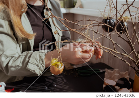 Female hands making egg shell handmade decoration for Easter holiday. Tutorial master class storytelling. Zero waste sustainable eco-friendly me made decor. Minimalistic 124543036