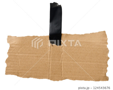 Torn piece of brown corrugated cardboard attached to black piece of electrical tape, isolated background Torn piece of brown corrugated cardboard attached to black piece of electrical tape, isolated background 124543676