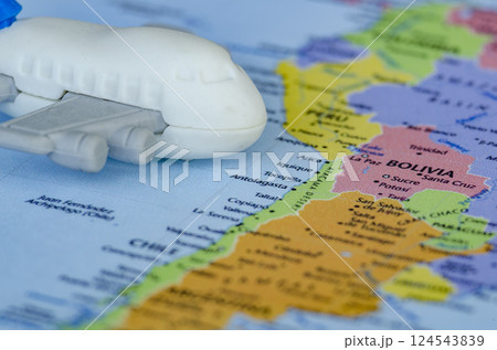 Close up of small toy airplane placed on a world map. Holiday and travel concept Close up of small toy airplane placed on a world map. Holiday and travel concept 124543839