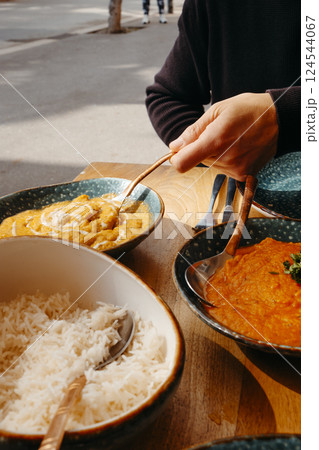 man about to serve some chicken korma man about to serve some chicken korma 124544067
